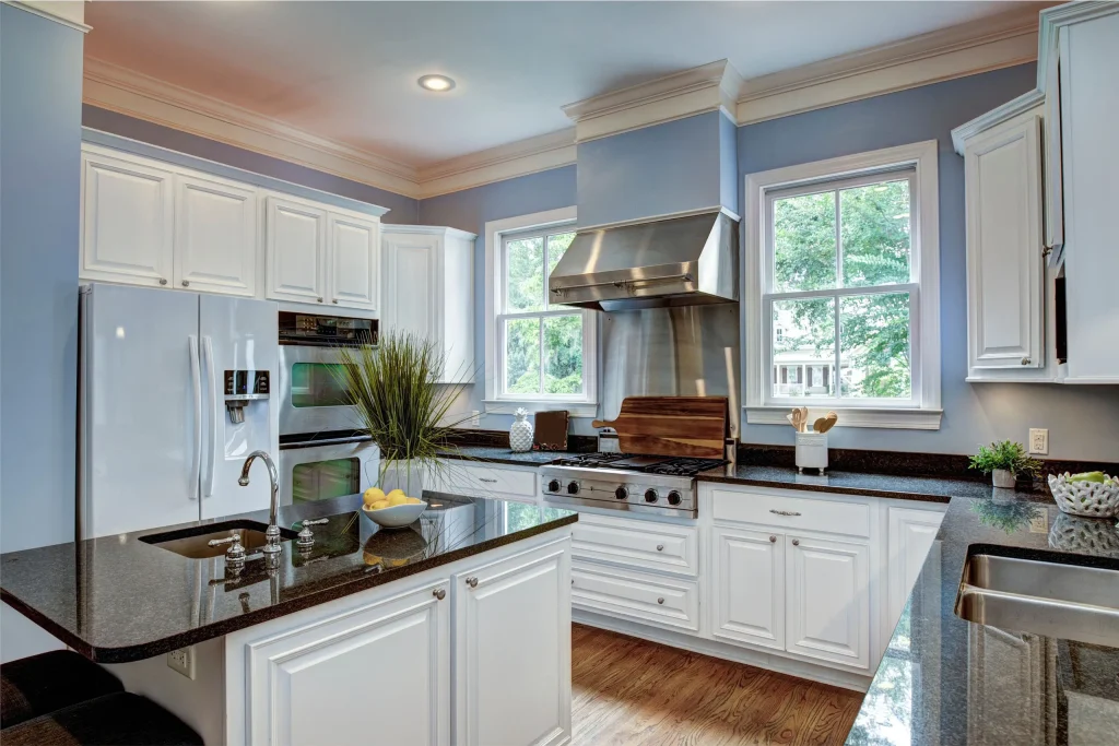 Large American style kitchen interior with granite countertops.